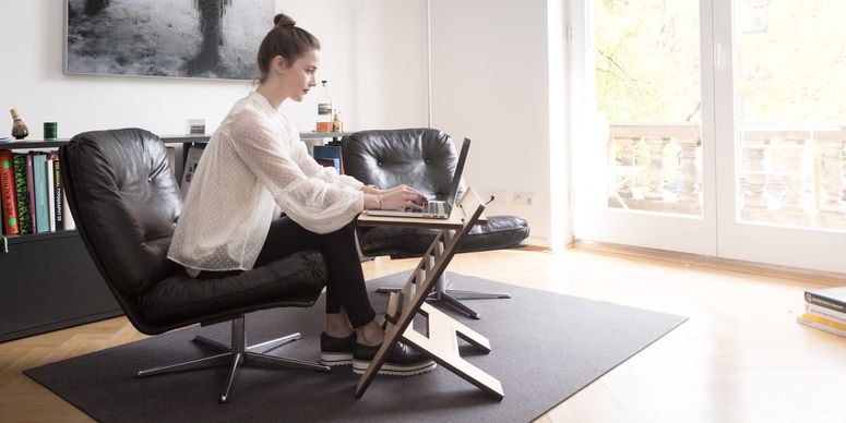 Young woman using laptop computer while working remotely from home